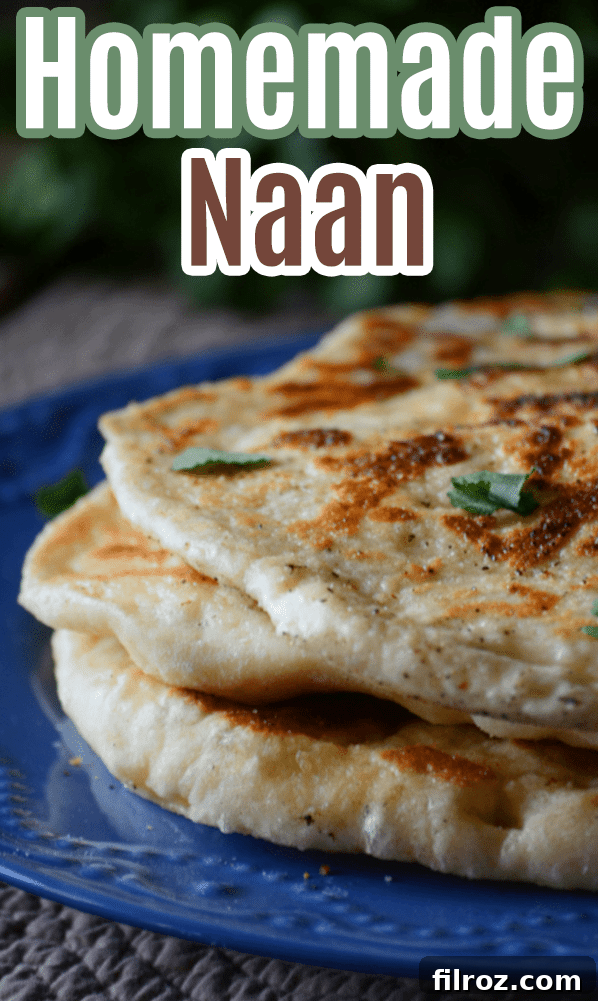 Freshly cooked naan bread on a wooden board, garnished with cilantro.