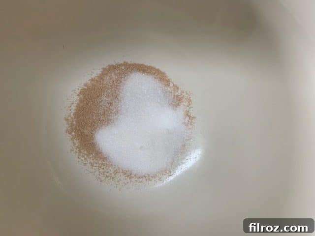Yeast proofing in a bowl with sugar and hot water.