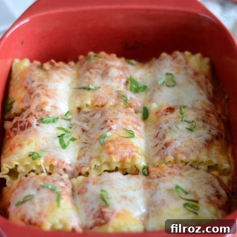 Delicious Veggie Stuffed Lasagna Roll-ups fresh out of the oven, topped with melted cheese