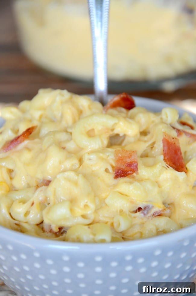 A dish of warm, inviting homemade mac and cheese with crispy bacon bits sprinkled on top, ready to be served.