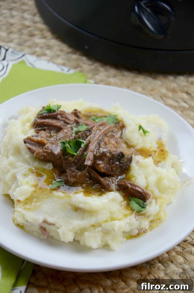 A beautifully cooked original Mississippi Pot Roast, shredded and ready to serve, showcasing its tender texture.