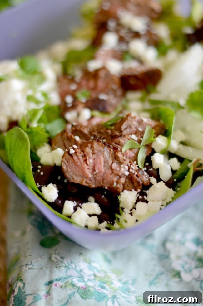 A fresh and vibrant steak taco salad in a bowl.