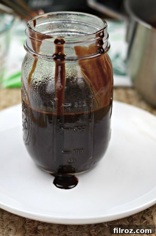 Homemade chocolate sauce with cocoa powder in a glass jar