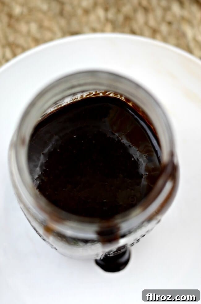 Homemade chocolate sauce with cocoa powder being drizzled