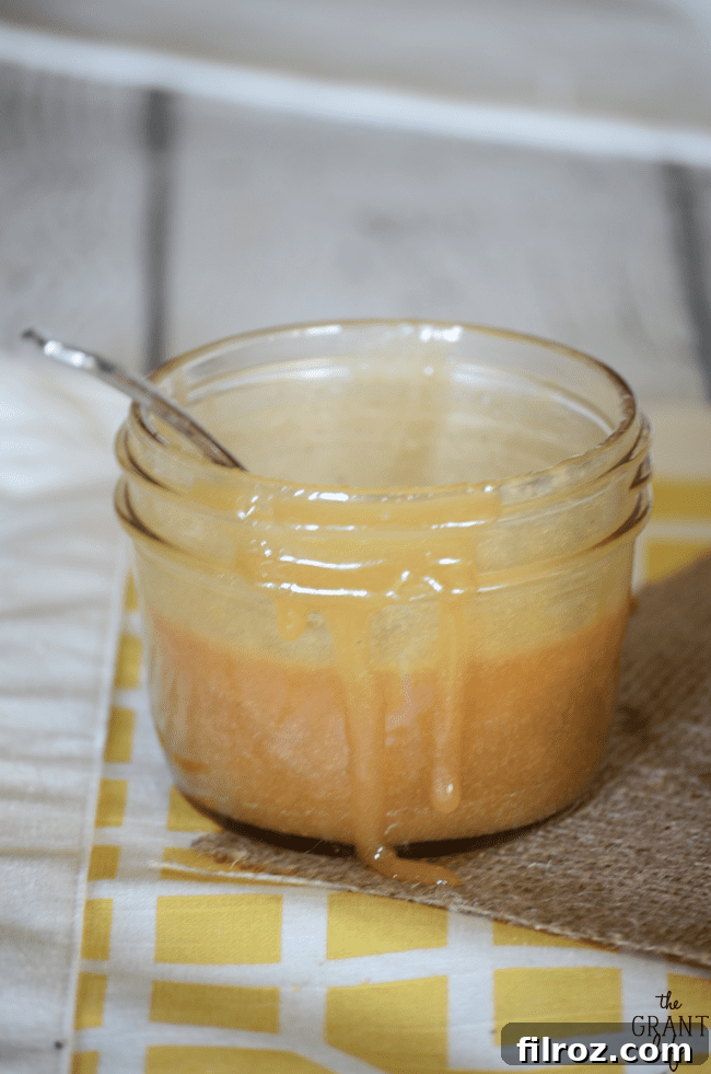 Rich homemade caramel sauce in a glass jar