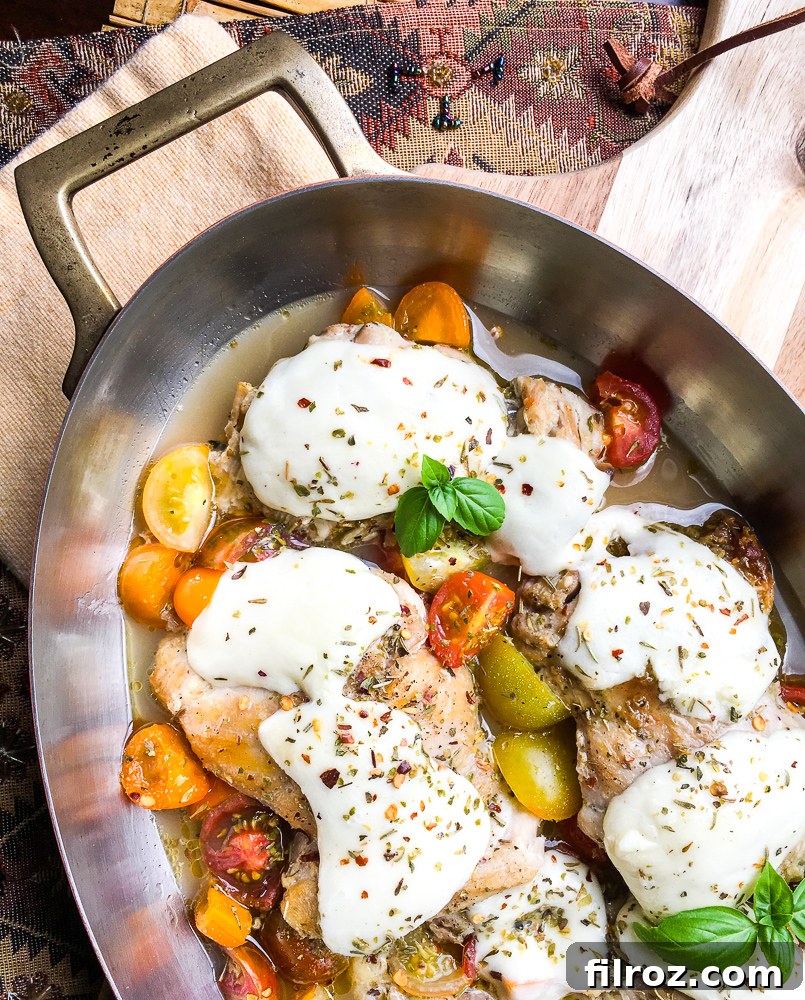 Close-up of easy chicken mozzarella recipe with melted cheese and tomatoes.