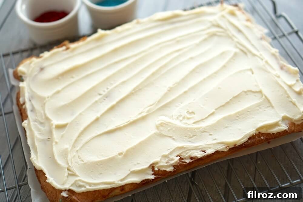 Buttery Sugar Cookie Bars 8 Smooth buttercream frosting on a spatula, ready for sugar cookie bars