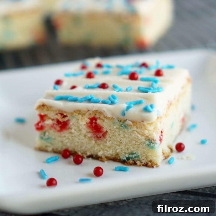 Red, white, and blue sugar cookie bars with sprinkles