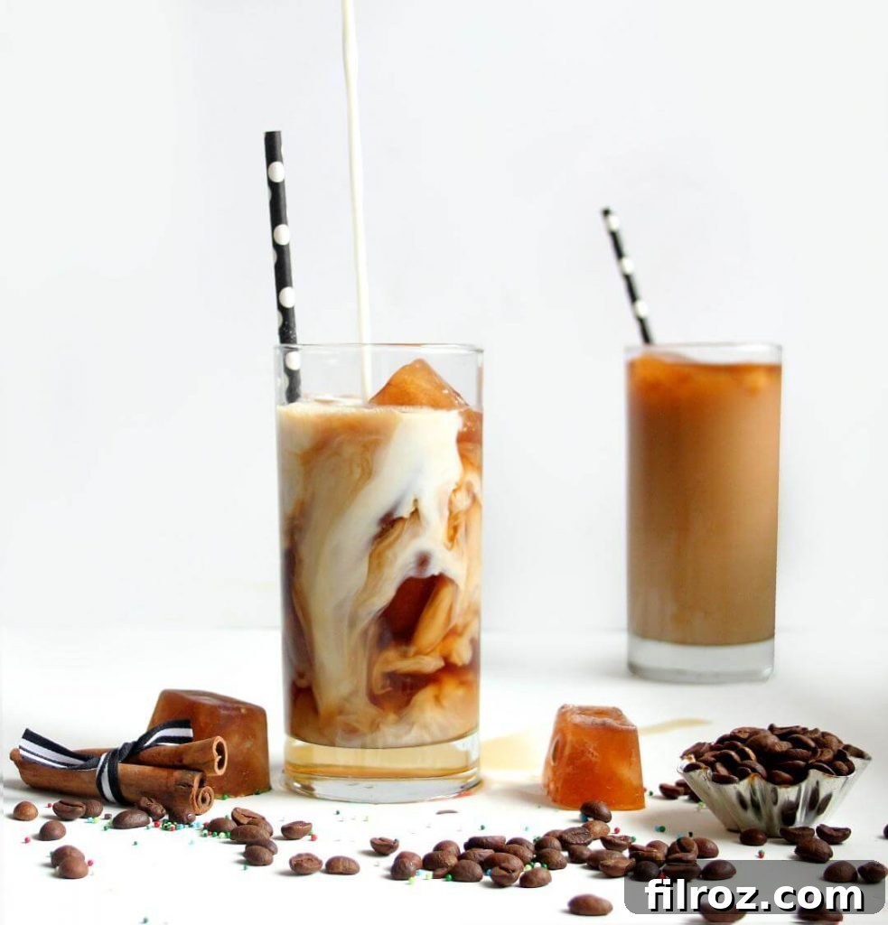 Close-up of a homemade iced vanilla latte with ice and a straw.