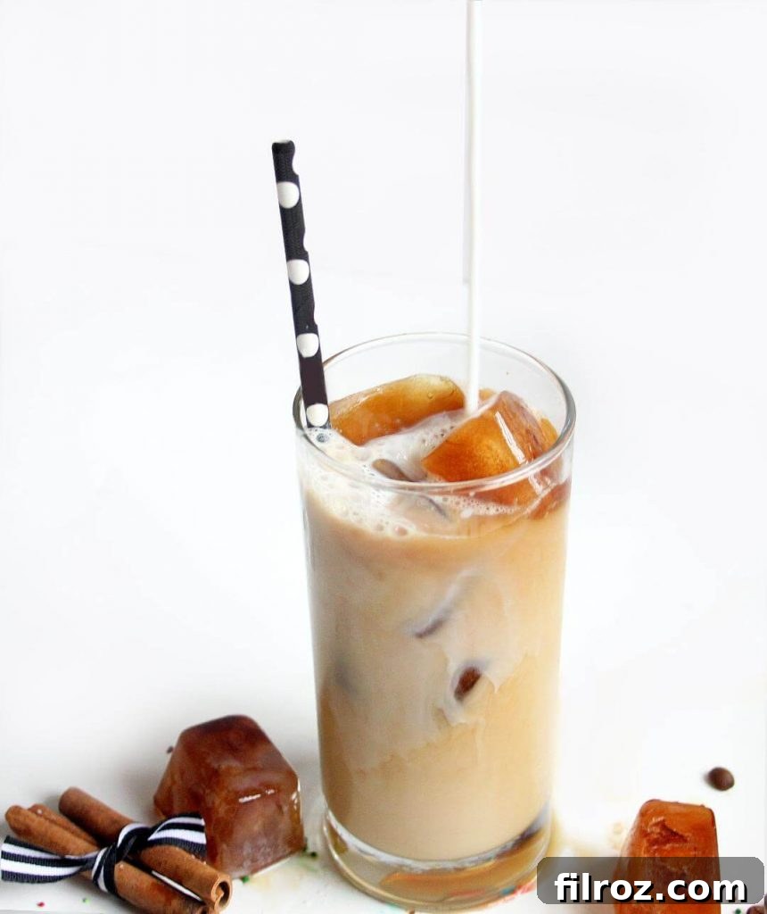 Ingredients for iced vanilla latte laid out: coffee, vanilla syrup, milk, and ice.