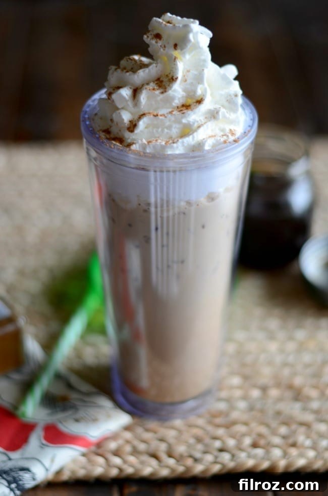 Iced Cinnamon Dolce Latte in a glass with cinnamon stick.