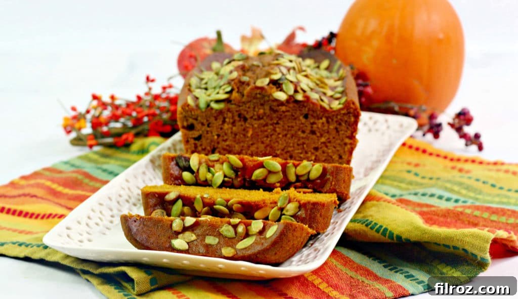 Close-up of a slice of Starbuck Pumpkin bread recipe, showing the dense texture and pumpkin seeds