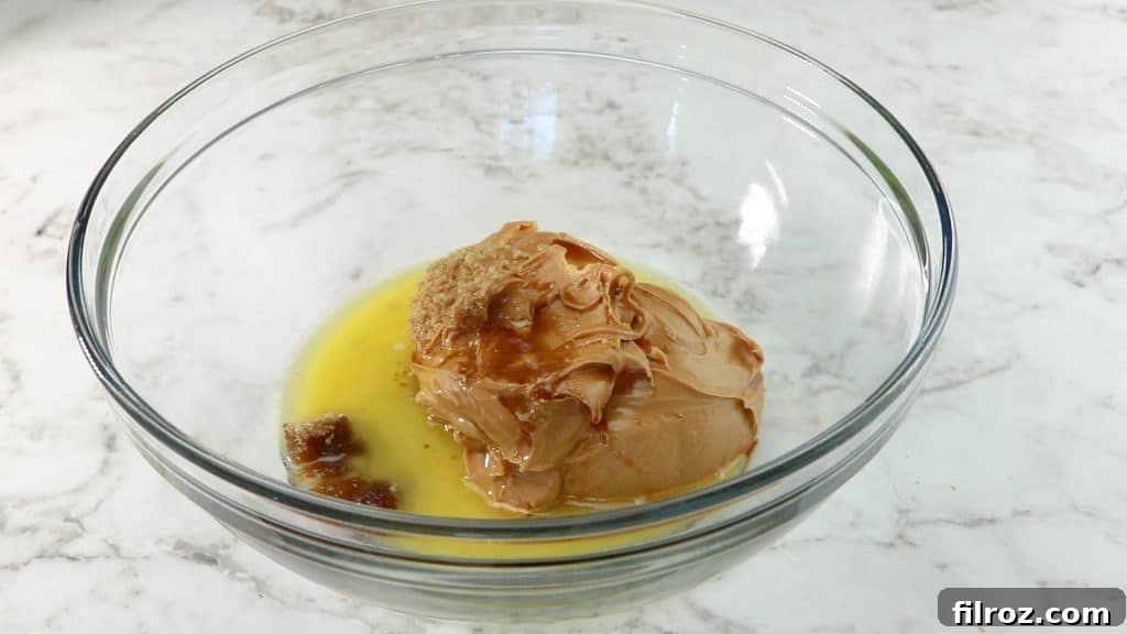 Mixing peanut butter, brown sugar, melted butter, and vanilla
