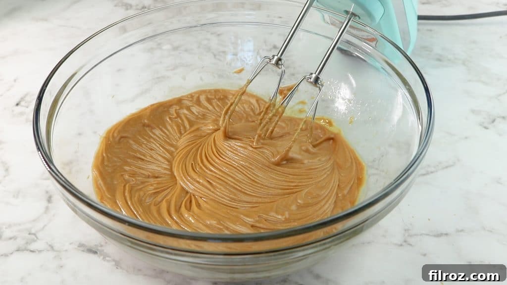 Adding powdered sugar to peanut butter mixture