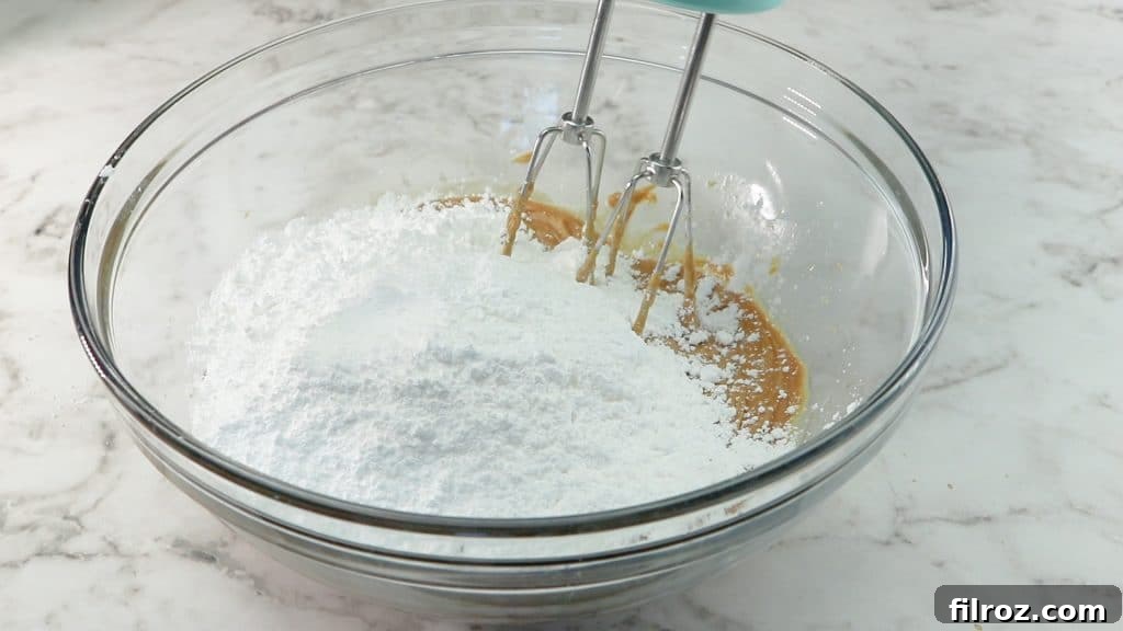 Pressing peanut butter mixture into a pan