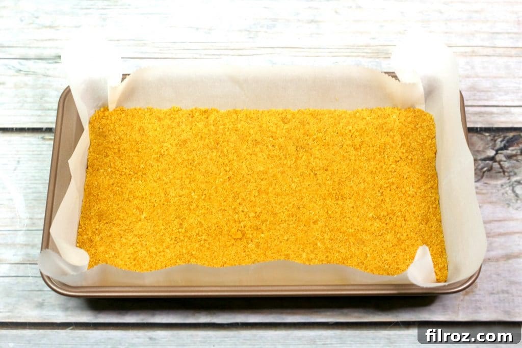 Mixing graham cracker crumbs and melted butter