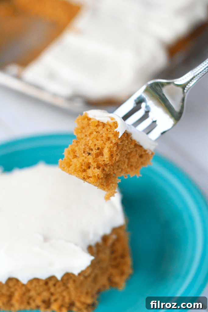 Spiced Pumpkin Bars with Cream Cheese Frosting 12 A slice of pumpkin bar with cream cheese frosting next to a cup of coffee