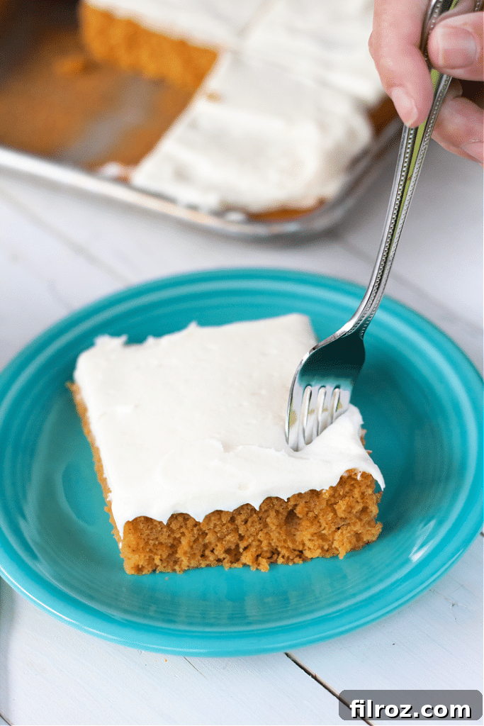 Spiced Pumpkin Bars with Cream Cheese Frosting 4 Freshly baked pumpkin bars cooling on a rack
