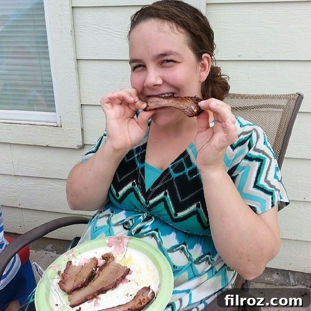 Happy customer enjoying Bohunk Barbecue's delicious ribs and sides at a catered event in Denton, TX.