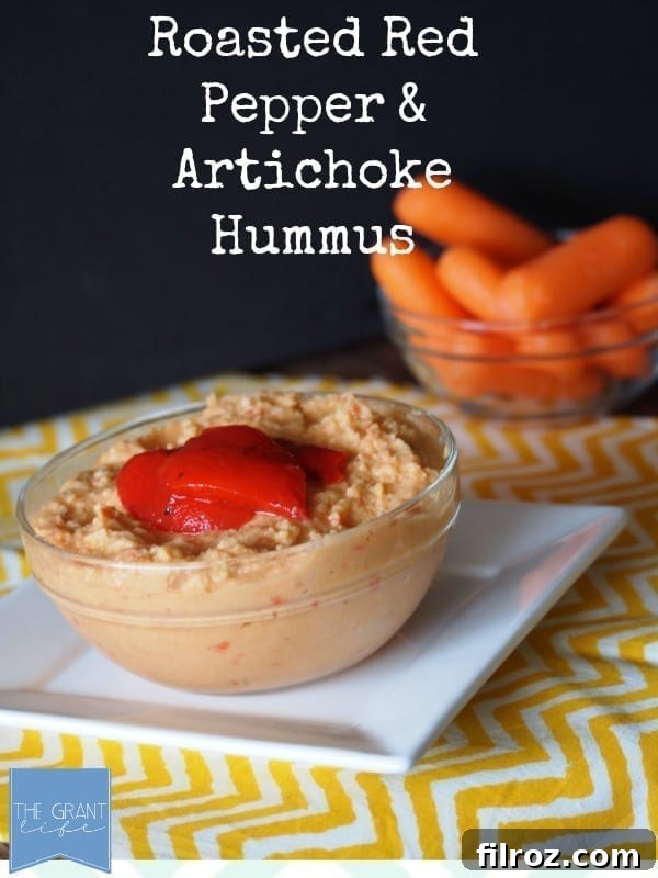 Homemade Roasted Red Pepper and Artichoke Hummus on a wooden table.
