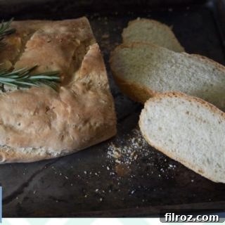 A whole loaf of homemade Rosemary and Sea Salt French Bread, ready to be sliced and served.