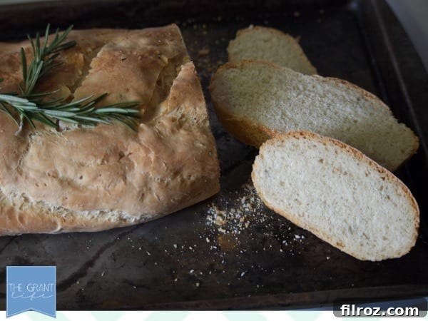 A delicious slice of Rosemary and Sea Salt French Bread, showing its fluffy interior.