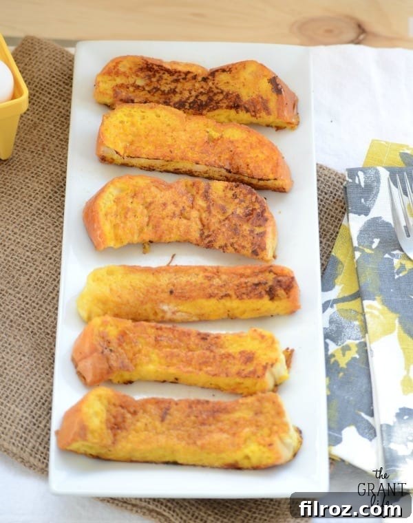 Beautifully styled image of Eggnog French Toast Sticks, ideal for sharing on social media platforms like Pinterest.